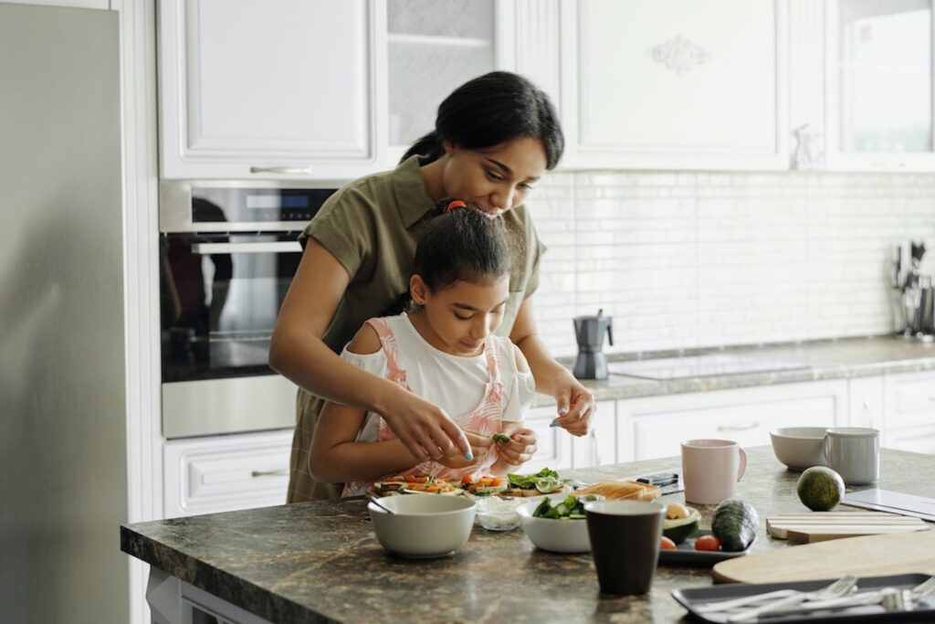 Mother and daughter preparing nutritious food to get rid of headaches through diet